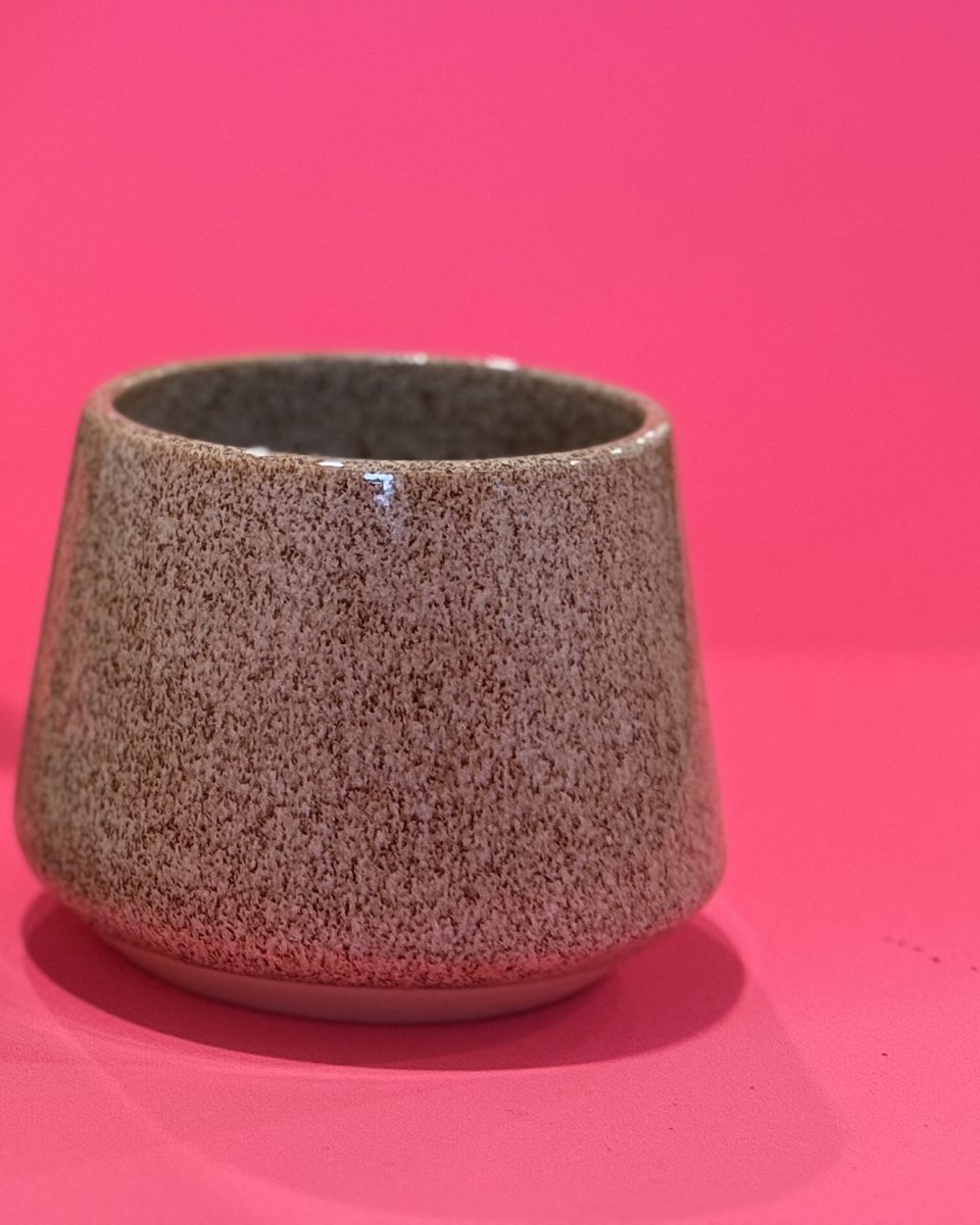 Speckled cup on a pink backdrop